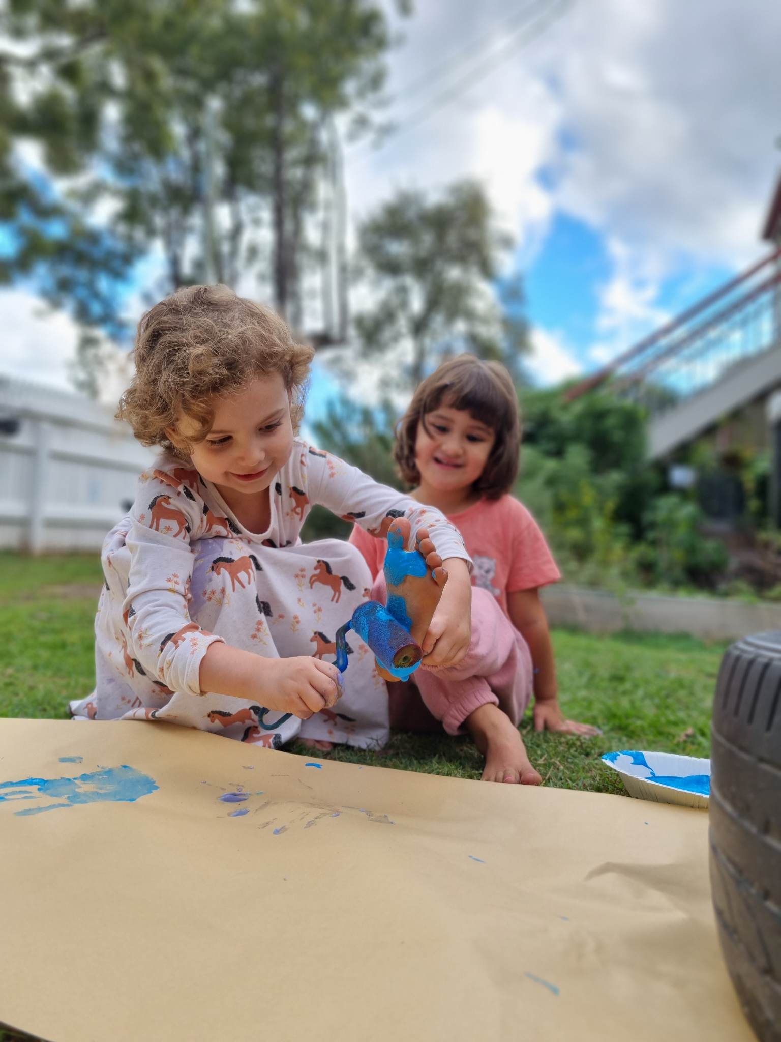 Children painting their feet and laughing