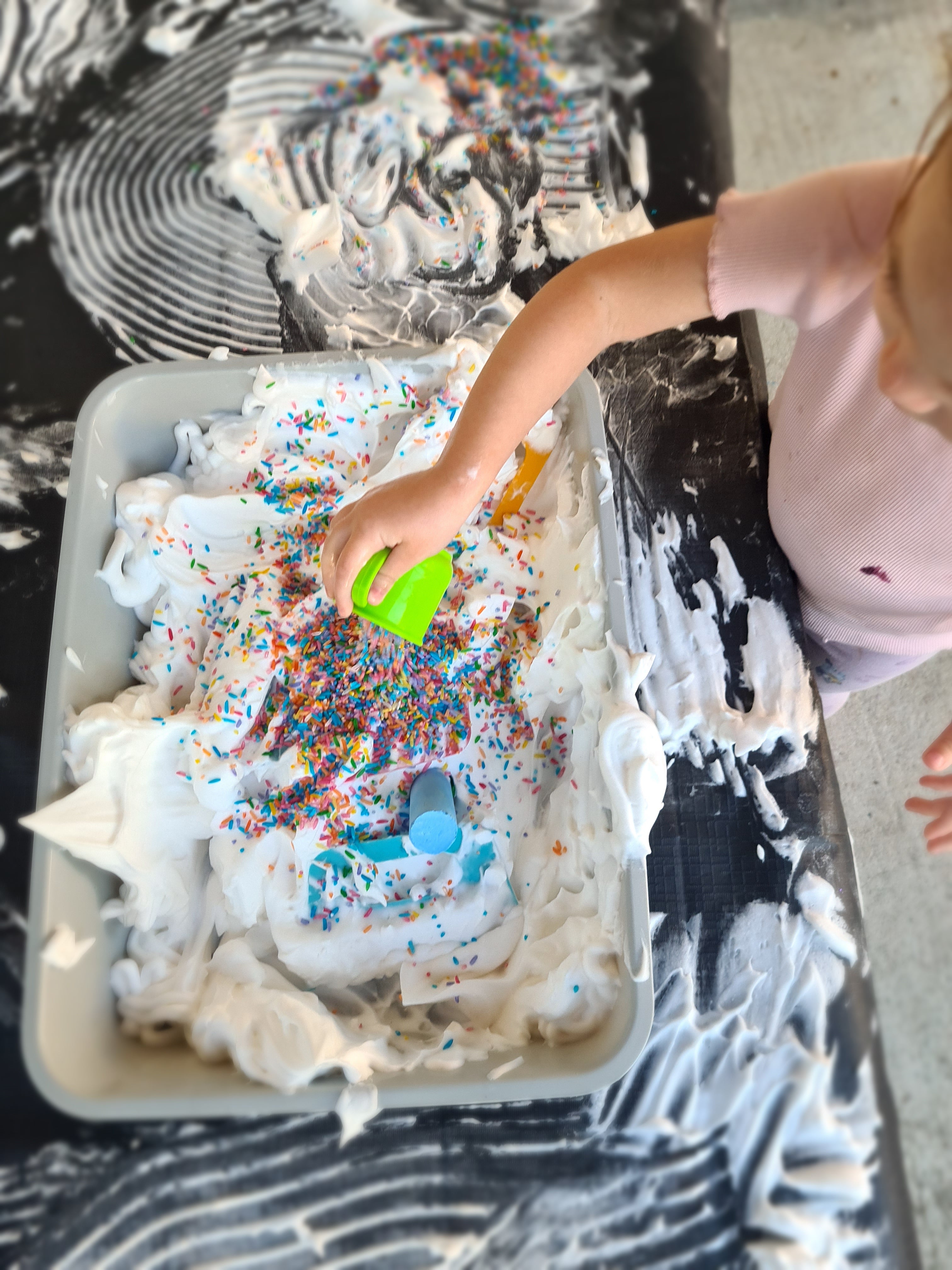 Child playing with foam at kids messy play class