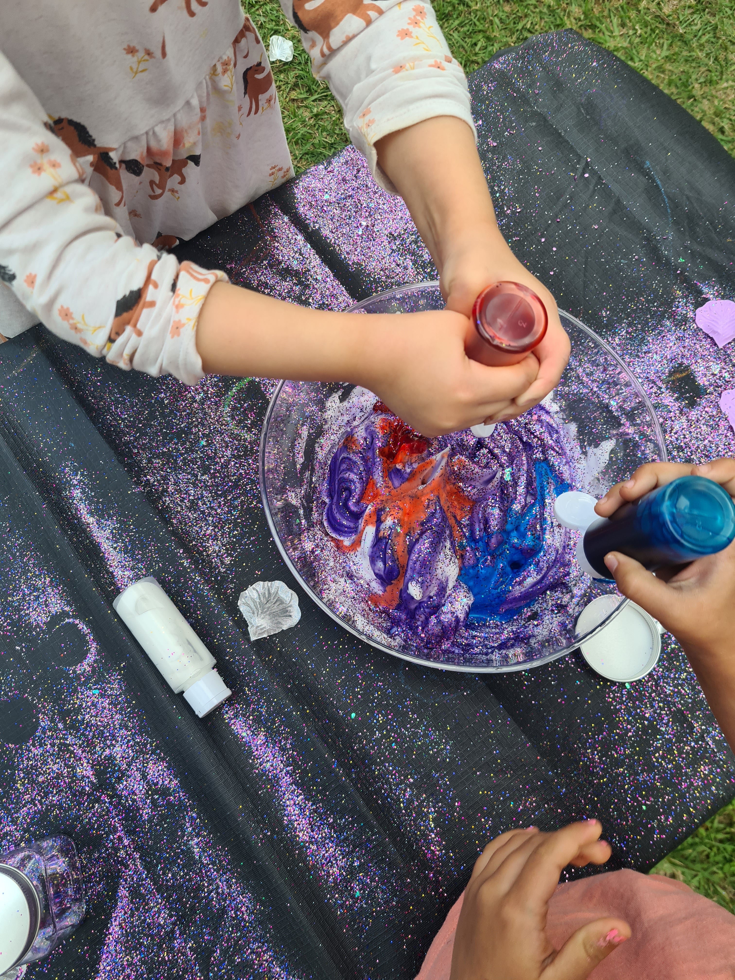Children playing with glitter, foam and food colouring